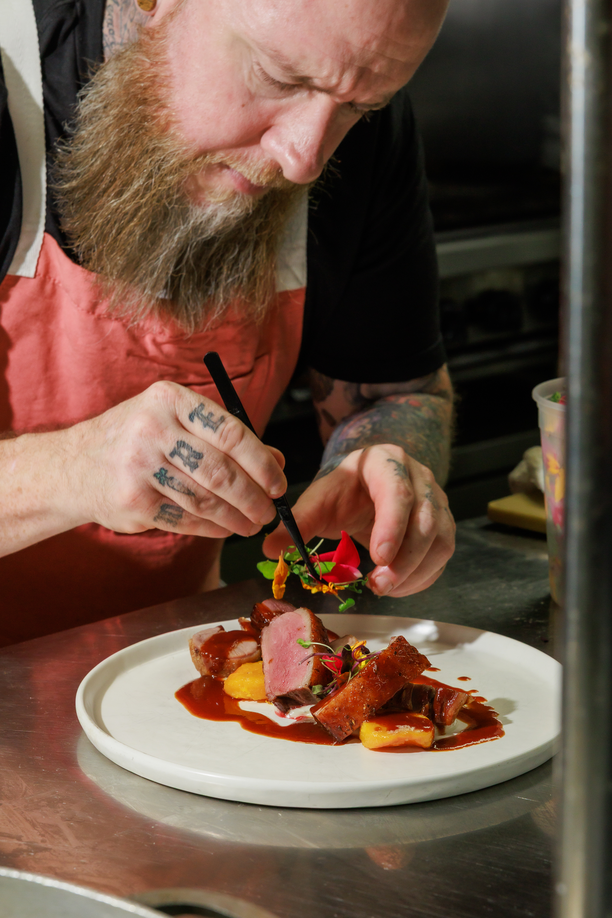 Executive Chef Michael Luth plating fine dining dishes at The Salty Zebra Bistro Jupiter FL